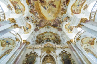 Beautifully decorated church ceiling in Baroque style with detailed frescoes and golden ornaments,