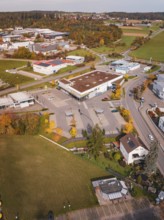 A gas station and industrial site surrounded by autumn leaves in a rural area, Althengstett, Calw