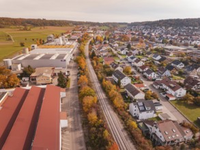 An autumnal panorama with a Hermann Hesse Railway railway line red roofs and residential buildings
