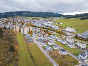 Aerial view of a city with autumn colors and clouds in the sky, Wehingen, Tuttlingen district,