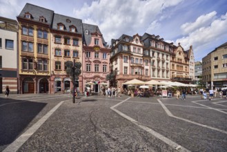Square made of paving stones and marble slabs with pattern, row of houses, reconstructed historic