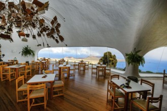 Interior of café with panoramic window in building designed by Cesar Manrique with the