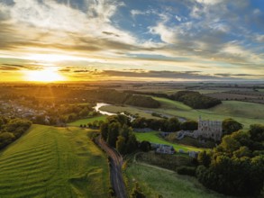 Sunset over Norham Castle and River Tweed from a drone, Norham, Northumberland, England, United