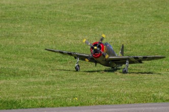 An RC model of a Republic P-47 Thunderbolt during a demonstration as part of an air show at the