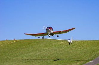 A Robin DR 400/200R Remorqueur light aircraft, registration D-EFGH, tows a glider during a flight
