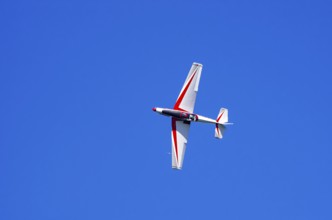 A single-engine aerobatic aircraft during a flight demonstration at the Rossfeld Luftsportverein in