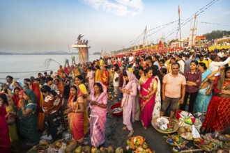 Hindu devotees gather on the banks of the Brahmaputra River to offer prayers to the Sun God on the