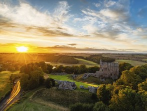 Sunset over Norham Castle and River Tweed from a drone, Norham, Northumberland, England, United