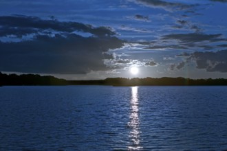 Atmospheric moonrise over Lake Gudelack, Lindow (Mark), Stechlin-Ruppiner Land nature park Park,