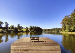 Footbridge with bench to Huwenowsee at Meseberg Castle Park, guest house and conference venue of