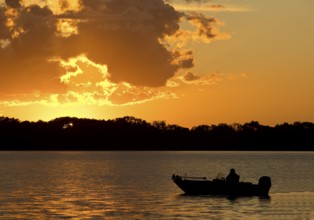 A boat on Lake Gudelack at sunset, Lindow (Mark), Stechlin-Ruppiner Land nature park Park,