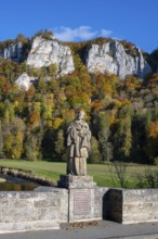 Statue, saint statue of Saint Nepomuk, patron saint of bridges, bridge saint on the historic arched