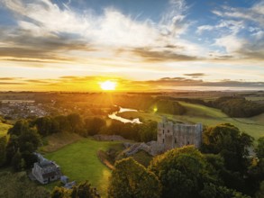 Sunset over Norham Castle and River Tweed from a drone, Norham, Northumberland, England, United