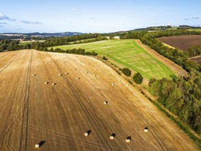 Straw bales in the Scottish fields from a drone, Southeast Scotland, UK
