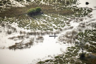 Marshland, marshland with canals, Kavango fishermen with his Mokoro, aerial view, Okavango Delta,
