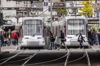 Pedestrians cross the tram tracks, at Düsseldorf-Bilk station, junction of S-Bahn, subway, tram,