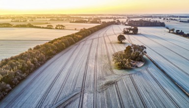 Bird Eye Perspective of Frost Covered Farmland. Seasonal Agricultural Scenery, winter and autumn