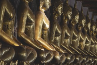 Gilded Buddha statues (Bhumispara mudra: Buddha Gautama at the moment of enlightenment), Wat Suthat