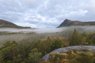 Magical morning fog on Steigtindvatnet in front of the majestic Litltind in Norway near Bodø