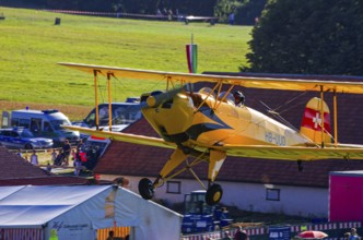 A biplane Bücker Bü 131 Jungmann with the registration HB-UUD during a flight demonstration as part