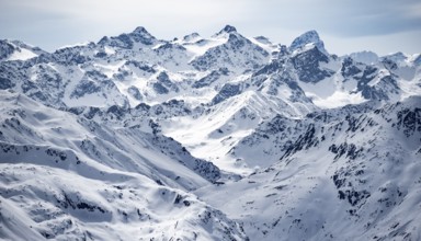 Mountain panorama with view of peaks of the Bernina Group, view from Piz Grialetsch in winter,