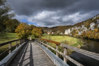Wooden bridge across the Danube to Käppeler Manor with St. George's Basilica near Thiergarten in