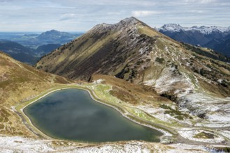 Reservoir, Kanzelwand snow-making pond, behind Fellhorn and mountains of the Allgäu Alps,