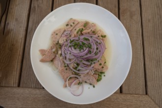 City sausage served with onions in a garden restaurant, Franconia, Bavaria, Germany