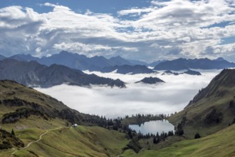 View of Seealpsee and Allgäu Alps, mountains rising from fog in the valley, Nebelhorn, Oberstdorf,