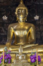 Golden Buddha statue, Phra Buddha Trilokachet surrounded by exquisite wall paintings, interior view
