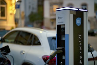 Parking lot with gas pump, EZE Network charging station, SICHARGE model for electric cars, charging