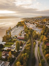 View of a marina with roads and autumn vegetation from above, Überlingen, Lake Constance, Germany