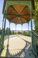 Historic metal pavilion with wooden ceiling surrounded by bright daylight and shade, Überlingen,