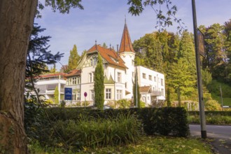 Historic house with tower surrounded by trees and a street, Überlingen, Lake Constance, Germany