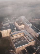 Urban industrial area seen from above in fog and dawn, new hospital health campus building, Calw,