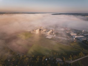 View of buildings in fog surrounded by landscape at the beginning of the day, new hospital health