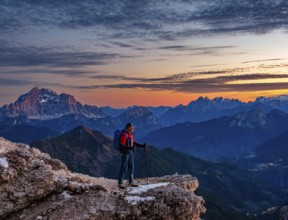 Mountaineers in front of rugged Dolomite peaks in the evening light, Dolomites, Alps, Belluno
