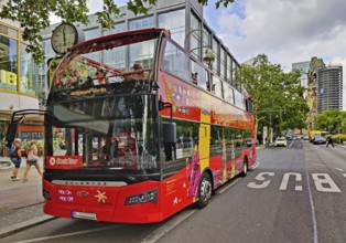 Double-decker bus for the city tour on Tauentzienstraße with Kaiser Wilhelm Memorial Church,