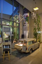 Entrance area to Monkey Bar with old Trabi in the evening, Charlottenburg, Berlin, Germany
