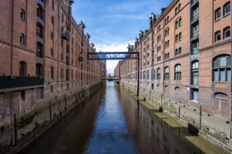 Canal between red brick buildings, warehouses in Hamburg's Speicherstadt, Hamburg, Germany