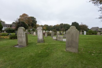 Cemetery of St John's Church with gravestones telling the story of seafarers, known as talking