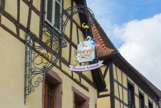 Historic guild sign of a bakery in the old town centre of Kaysersberg
