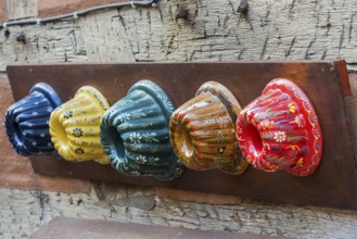 Traditional colourful Guglhupf cake tins from a bakery in Kaysersberg