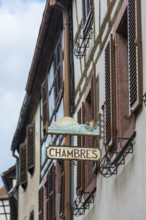 Historic guild sign of a guesthouse in the old town centre of Kaysersberg