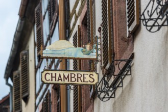 Historic guild sign of a guesthouse in the old town centre of Kaysersberg