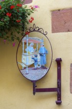 Historic guild sign of an ice cream parlour in the old town of Kaysersberg