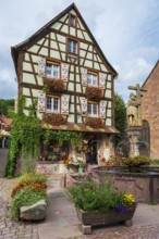 Emperor Constantin fountain in front of a half-timbered house in Kaysersberg