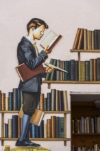 Historical wall relief with young pupil at the library, Ribeauvillè