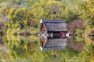Boathouse on Lake Max-Eyth in autumn with colourful foliage. Stuttgart, Baden-Württemberg, Germany