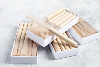 Cigarette casings, packed in boxes, on the table, top view